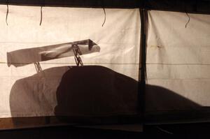 One of the Fix Rim Team Chevy Camaros casts a shadow on the tent.