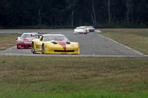 The field streams into turn four on lap two.