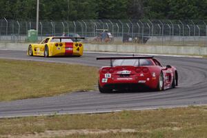 Amy Ruman's Chevy Corvette chases Tony Ave's Chevy Corvette through turn 4.