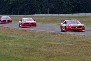 Bob Stretch's Chevy Camaro, Pete Halsmer's Chevy Camaro and Cameron Lawrence's Chevy Camaro battle for the lead in TA2.