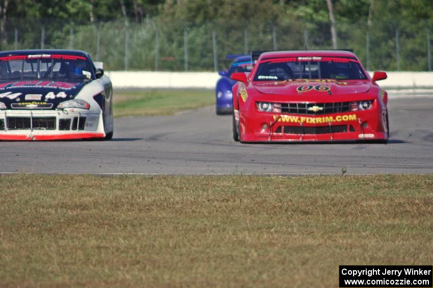 Bob Stretch's Chevy Camaro passes John Cottrell's Chevy Monte Carlo into turn 12,