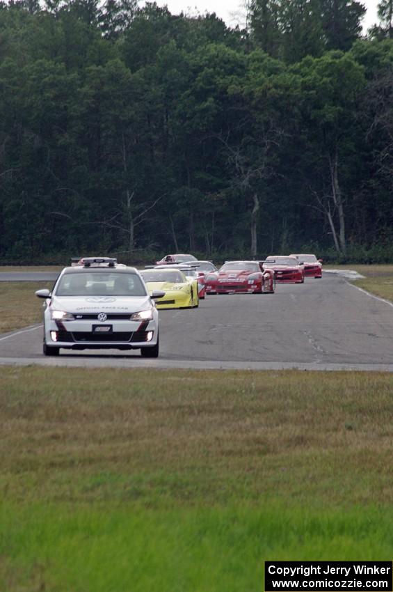 The field streams into turn four on the pace lap.