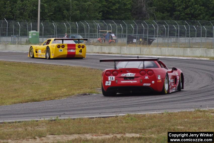 Amy Ruman's Chevy Corvette chases Tony Ave's Chevy Corvette through turn 4.