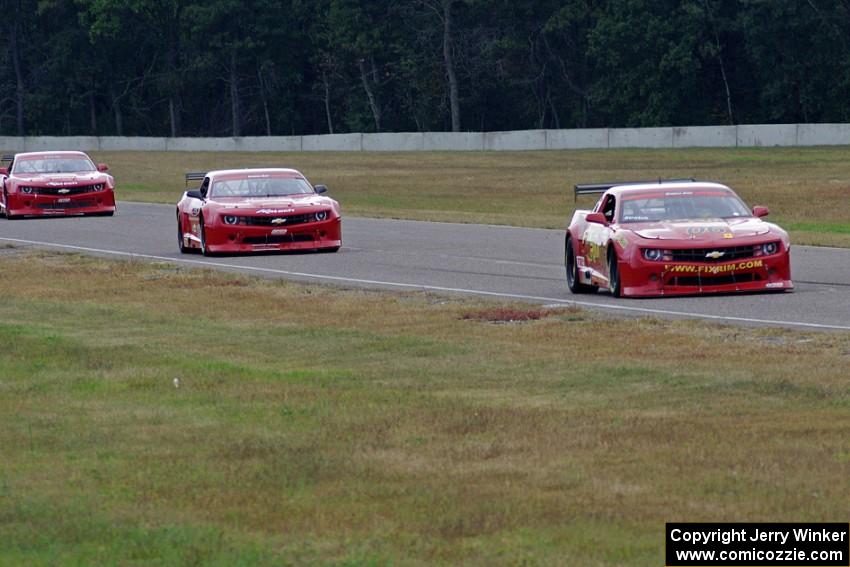 Bob Stretch's Chevy Camaro, Pete Halsmer's Chevy Camaro and Cameron Lawrence's Chevy Camaro battle for the lead in TA2.