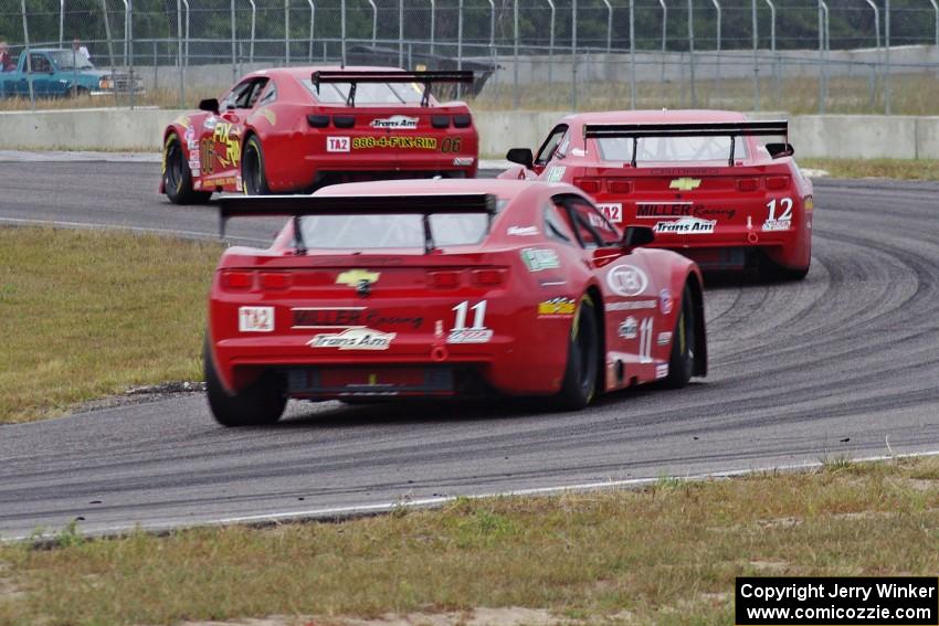 Bob Stretch's Chevy Camaro, Pete Halsmer's Chevy Camaro and Cameron Lawrence's Chevy Camaro battle for the lead in TA2.