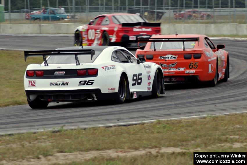 Mike Wilson's Chevy Monte Carlo, Tom Sheehan's Chevy Camaro and Cris Liesfeld's Chevy Camaro at turn 4.