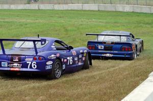 After Matt Crandall's Ford Mustang pulls off at turn 4, Chuck Cassaro's Panoz GTS does the same.