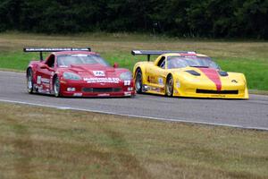 Tony Ave's Chevy Corvette and Amy Ruman's Chevy Corvette go side-by-side into turn 4.