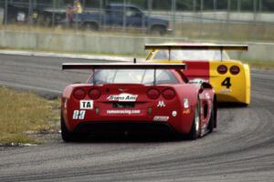 Amy Ruman's Chevy Corvette chases Tony Ave's Chevy Corvette through turn 4.