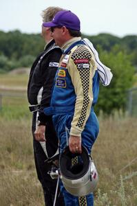 Chuck Cassaro and Matt Crandall watch the race from the concrete barrier at turn 4.