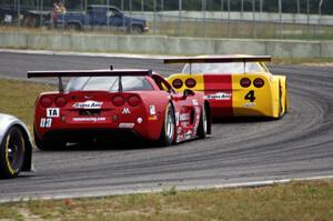 Amy Ruman's Chevy Corvette chases Tony Ave's Chevy Corvette through turn 4.