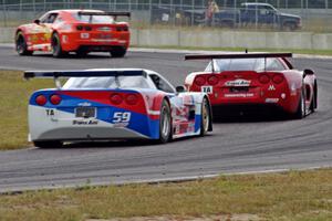 Amy Ruman's Chevy Corvette holds off Simon Gregg's Chevy Corvette at turn 4 on the last lap.