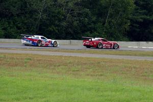 Amy Ruman's Chevy Corvette holds off Simon Gregg's Chevy Corvette at turn 5 on the last lap.