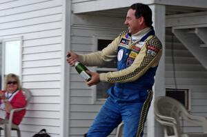 Chuck Cassaro sprays the crowd with champagne.