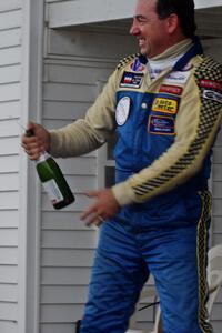 Chuck Cassaro sprays the crowd with champagne.