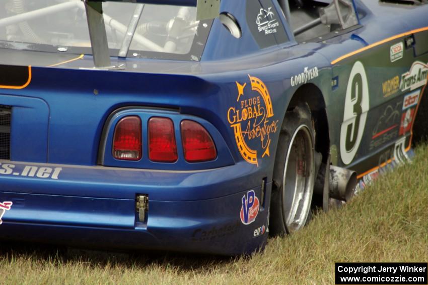 Matt Crandall's Ford Mustang pulls off at turn 4 with a blown tire.