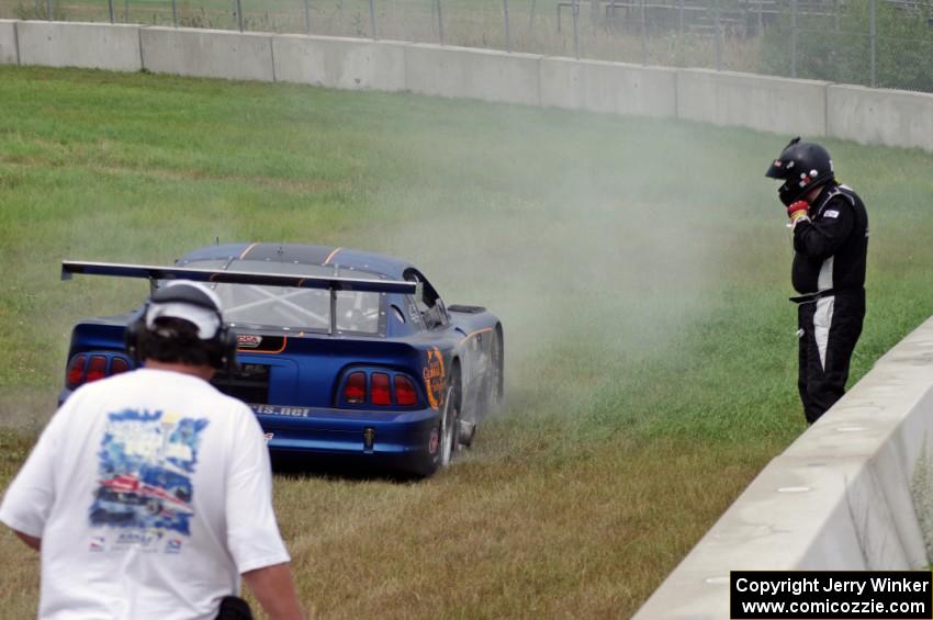 Matt Crandall's Ford Mustang pulls off at turn 4 with a blown tire.