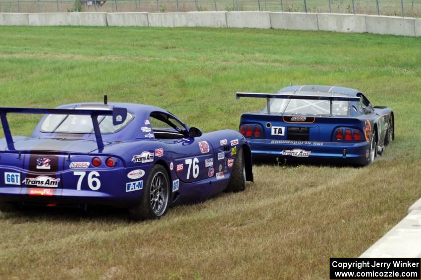 After Matt Crandall's Ford Mustang pulls off at turn 4, Chuck Cassaro's Panoz GTS does the same.