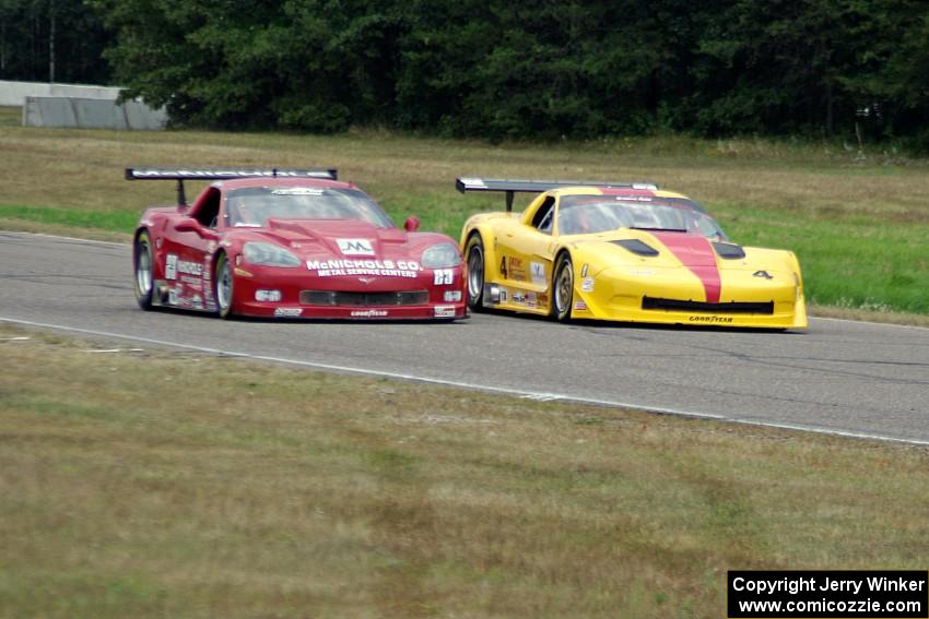Tony Ave's Chevy Corvette and Amy Ruman's Chevy Corvette go side-by-side into turn 4.
