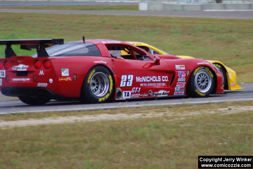 Tony Ave's Chevy Corvette nips Amy Ruman's Chevy Corvette into turn 4.