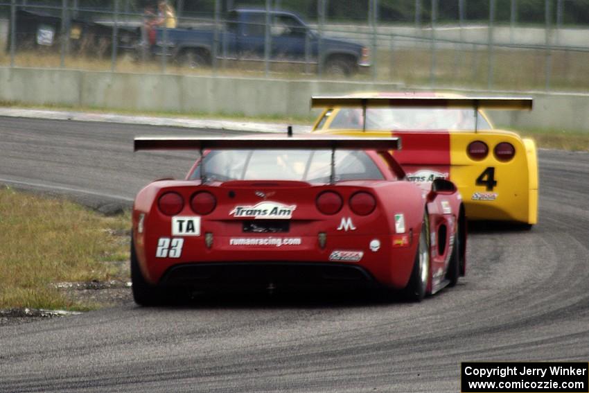 Amy Ruman's Chevy Corvette chases Tony Ave's Chevy Corvette through turn 4.