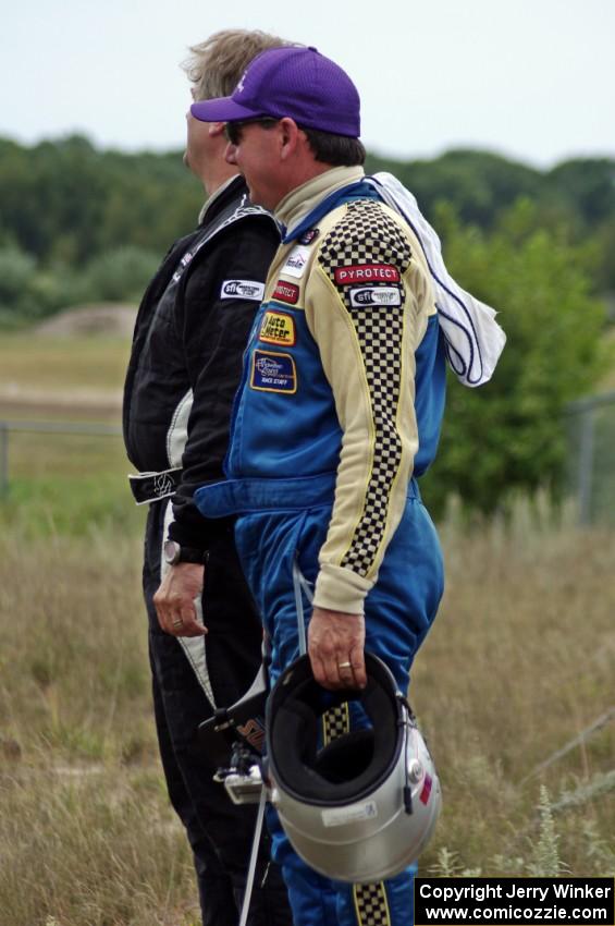 Chuck Cassaro and Matt Crandall watch the race from the concrete barrier at turn 4.