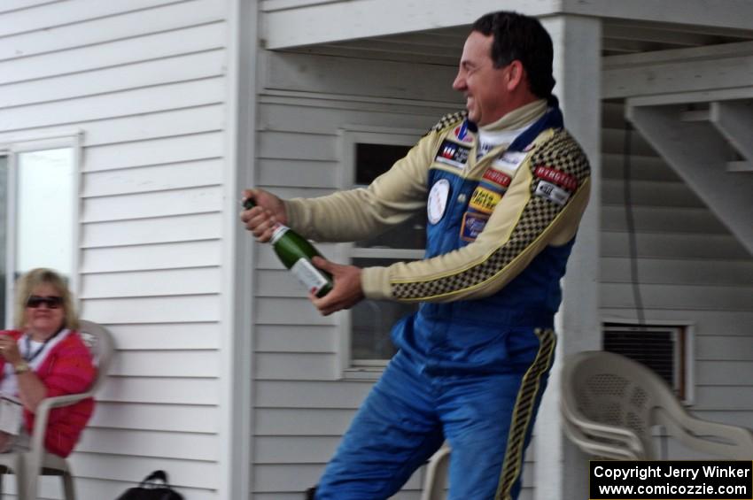 Chuck Cassaro sprays the crowd with champagne.