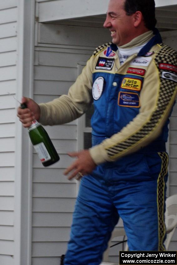 Chuck Cassaro sprays the crowd with champagne.