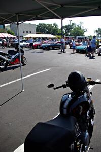 Italian motorcycles on one side with Italian cars on the other