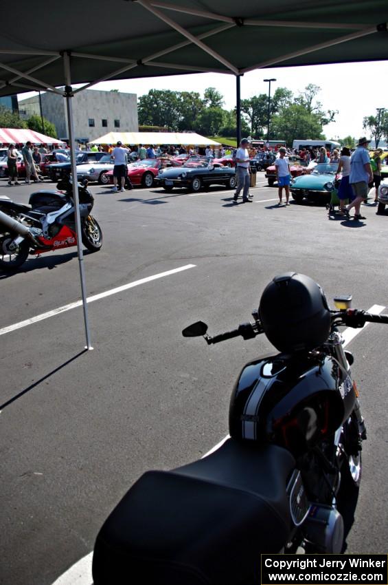 Italian motorcycles on one side with Italian cars on the other