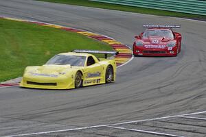 Doug Peterson's Chevy Corvette leads Amy Ruman's Chevy Corvette through Canada Corner on lap one
