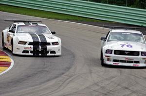 Joe Ebben's Ford Mustang goes to the inside of Chuck Cassaro's Ford Mustang