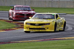 Bob Stretch's Chevy Camaro and Cameron Lawrence's Chevy Camaro battle for the lead in TA2