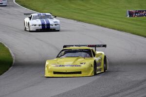 Doug Peterson's Chevy Corvette and Cliff Ebben's Ford Mustang enter the carousel