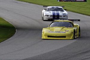Doug Peterson's Chevy Corvette and Cliff Ebben's Ford Mustang enter the carousel