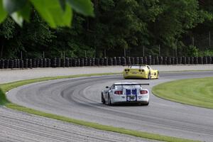 Cliff Ebben's Ford Mustang chases Doug Peterson's Chevy Corvette through the carousel