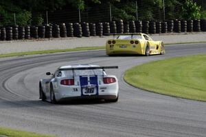 Cliff Ebben's Ford Mustang chases Doug Peterson's Chevy Corvette through the carousel