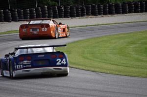 Rick Dittman's Chevy Corvette chases David Fershtand's Chevy Corvette through the carousel