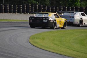 John Atwell's Chevy Camaro chases Kurt Roehrig's Chevy Camaro through the carousel