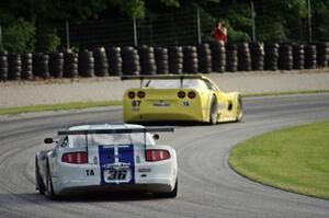 Cliff Ebben's Ford Mustang chases Doug Peterson's Chevy Corvette through the carousel