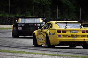 Tom Sheehan's Chevy Camaro chases John Atwell's Chevy Camaro through the carousel