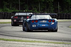 Jordan Bupp's Chevy Corvette chases Tom West's Ford Mustang through the carousel