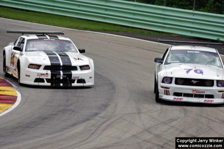 Joe Ebben's Ford Mustang goes to the inside of Chuck Cassaro's Ford Mustang
