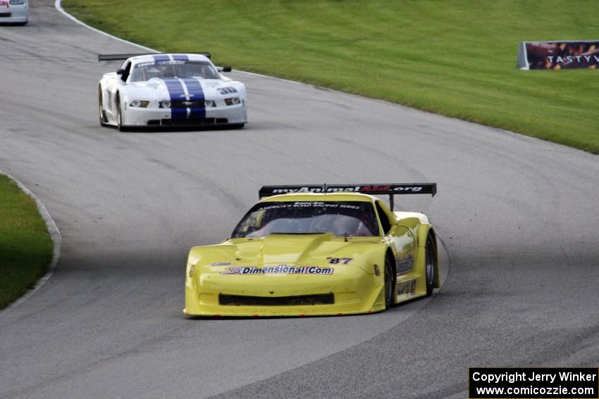 Doug Peterson's Chevy Corvette and Cliff Ebben's Ford Mustang enter the carousel