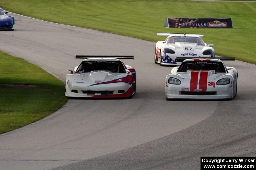 Simon Gregg's Chevy Corvette passes Kyle Kelly's Chevy Corvette as Dave Pintaric's Chevy Corvette follows