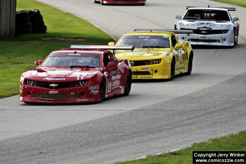 The Chevy Camaros of Cameron Lawrence, Bob Stretch and Rob Huffmaster enter the carousel