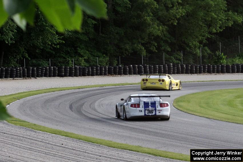 Cliff Ebben's Ford Mustang chases Doug Peterson's Chevy Corvette through the carousel