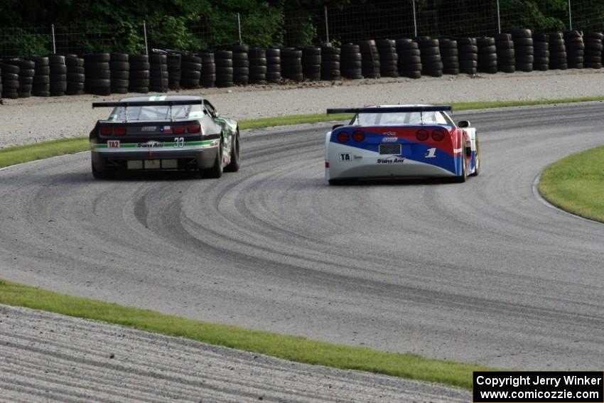 Simon Gregg's Chevy Corvette passes Gregg Rodgers's Chevy Camaro in the carousel