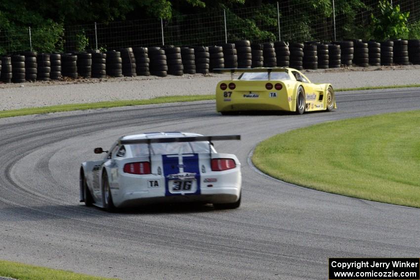 Cliff Ebben's Ford Mustang chases Doug Peterson's Chevy Corvette through the carousel