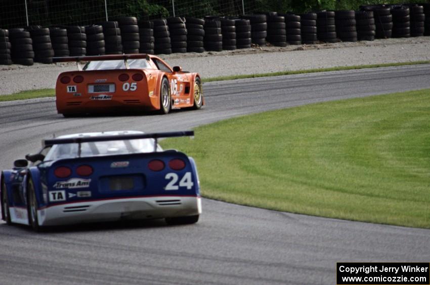 Rick Dittman's Chevy Corvette chases David Fershtand's Chevy Corvette through the carousel